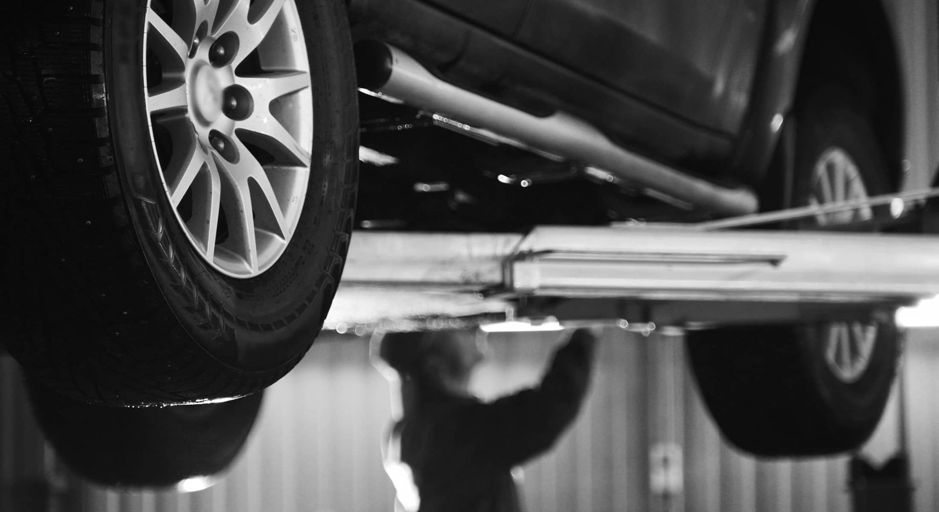 Vehicle raised on a service lift in the shop bay at Monticello Tire Company