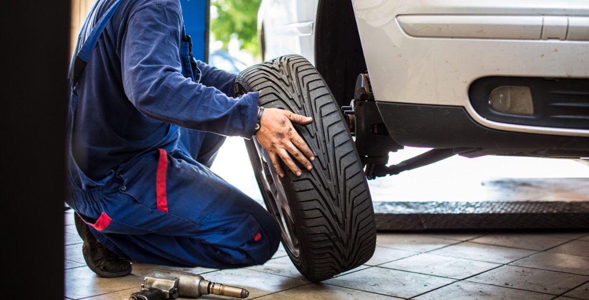 Mechanic changing a tire for a customer at Monticello Tire Company in Monticello, MS