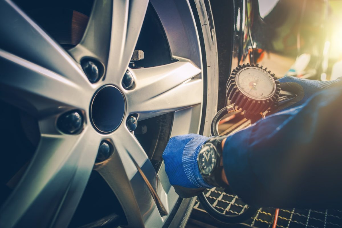 Technician torquing a wheel on a car at Monticello Tire Company in Monticello, MS