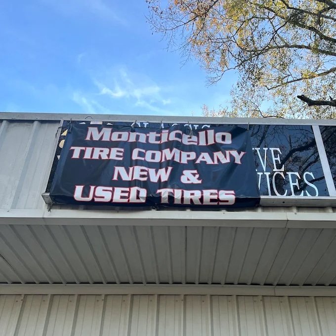 Monticello Tire Company banner sign advertising new and used tires in Monticello, MS